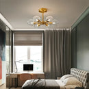Modern Copper Glass Ball Chandelier in a stylish bedroom with neutral decor and natural light.