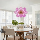 Glorious Tinted Glass Bubble Chandelier illuminating a modern dining room with pink bulbs.