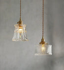 Elegant Glass Pendant Light with Brass Accents - Illuminate with Style features two stylish designs with glass and brass.