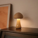 Portable Dimmable 60s Italy Designer Mushroom Table Lamp on wooden table with warm light.