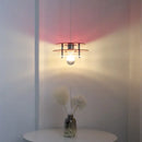 Space Age Acrylic Colorful Pendant Light hanging above a table, casting vibrant colored shadows on the wall.