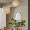 Japanese Rice Paper Pendant Lights hanging in a chic modern interior with a plant and wall mirror.