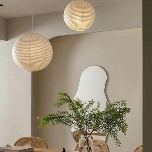 Japanese Rice Paper Pendant Lights hanging in a chic modern interior with a plant and wall mirror.