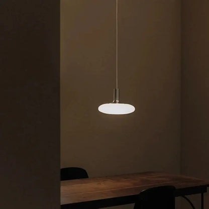 Nordic UFO LED Pendant Light – Minimalist Floating Disc Ceiling Lamp illuminating a dining area.