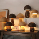 Portable Dimmable 60s Italy Designer Mushroom Table Lamp collection on a shelf, showcasing various styles and warm glow.