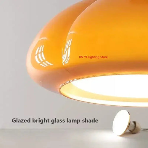 The Ideal Modern Kitchen Glass Pendant featuring a glazed bright orange glass lamp shade for stylish illumination.
