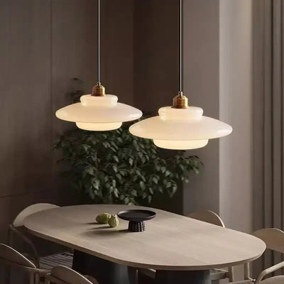 Nordic Vintage Pendant Light | Scandinavian Chic Decor hanging over a dining table, featuring cream wind milk glass and layered design.