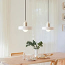 Italian Glass 70s Pendant Lights | Vintage Elegance | Shop Now! hanging over a modern dining table.