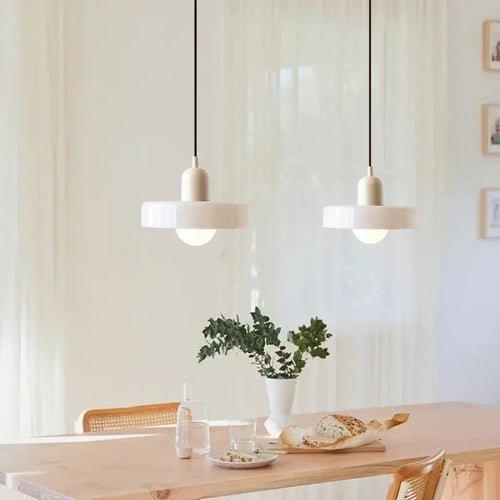 Italian Glass 70s Pendant Lights | Vintage Elegance | Shop Now! hanging over a modern dining table.