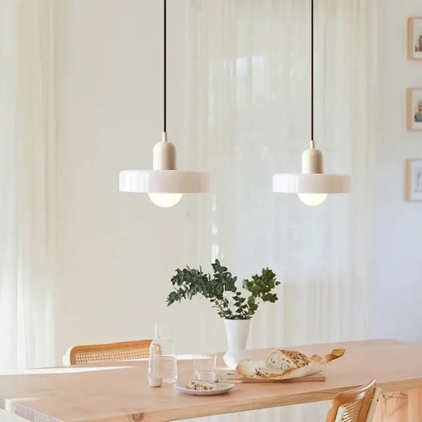 Italian Glass 70s Pendant Lights | Vintage Elegance | Shop Now! hanging over a modern dining table.