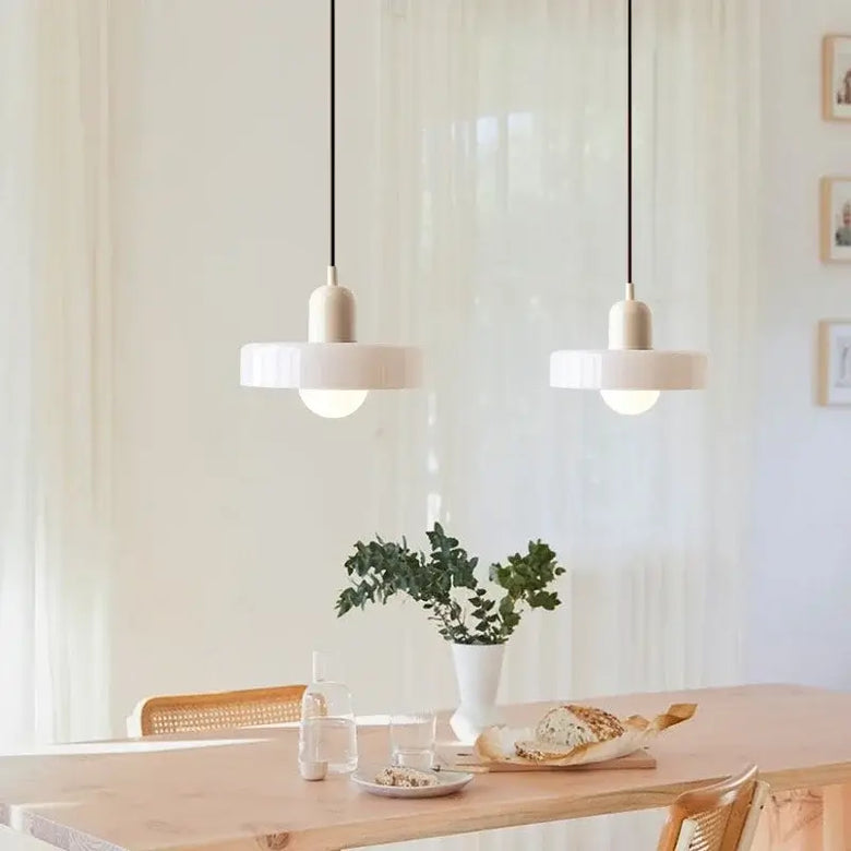Italian Glass 70s Pendant Lights | Vintage Elegance | Shop Now! hanging over a modern dining table.