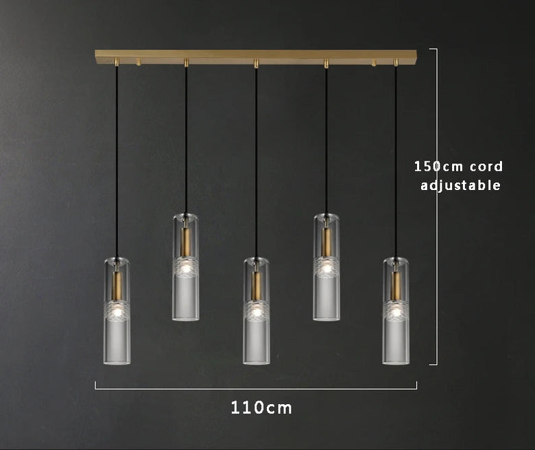 Five-light linear pendant chandelier with clear cylindrical crystal glass shades, copper-toned internal rods, and black hanging cords, shown on a dark gray background with dimension labels reading 110cm width and 150cm cord adjustable.