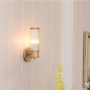 Bathroom Art Deco Brass and Crystal Sconces with a crystal shade illuminating a stylish bathroom wall.