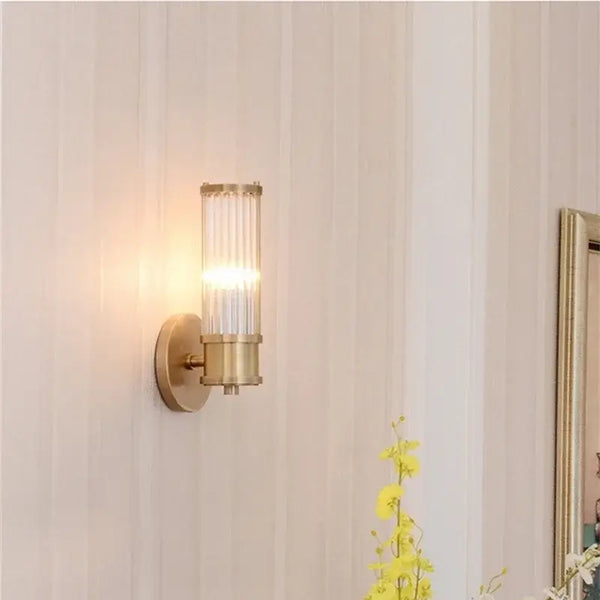 Bathroom Art Deco Brass and Crystal Sconces with a crystal shade illuminating a stylish bathroom wall.