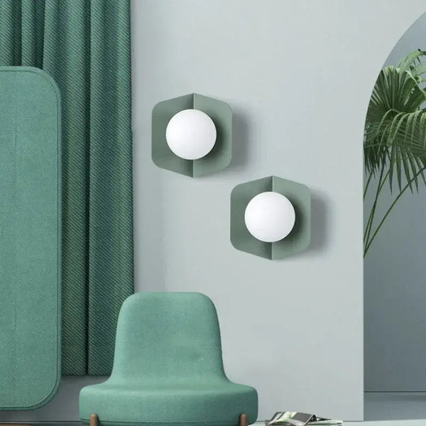 Chic Modern Sconce Collection – Illuminate with Style showcased in a stylish green room with contemporary design elements.