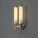 Stylish Art Deco Brass Wall Lamp illuminating a modern space with its frosted glass and brass design.