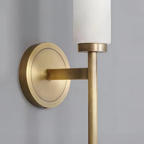 Stylish Art Deco Brass Wall Lamp close-up showing the frosted glass and luxurious brass finish.