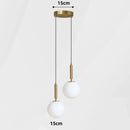 Modern Gold Glass Ball Pendant featuring two white glass balls suspended from a gold ceiling mount.