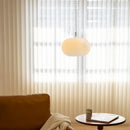 Bauhaus Glass Chandeliers with bright cord hanging in a bright room with sheer curtains.