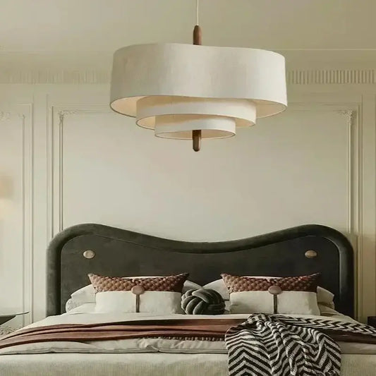 Elegant Linen Fabric Chandelier hanging above a stylish bed in a sophisticated bedroom setting.