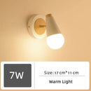 Wood and Frosted Glass Japanese Minimalist Sconces illuminating a warm light in a modern design.