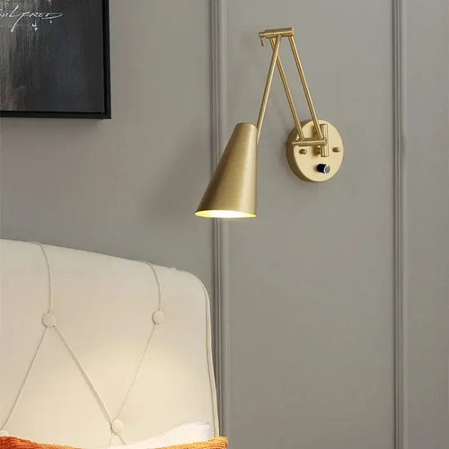 Vintage Loft Bedside Reading Light Fixture mounted on wall beside a tufted bed, showcasing its elegant design.