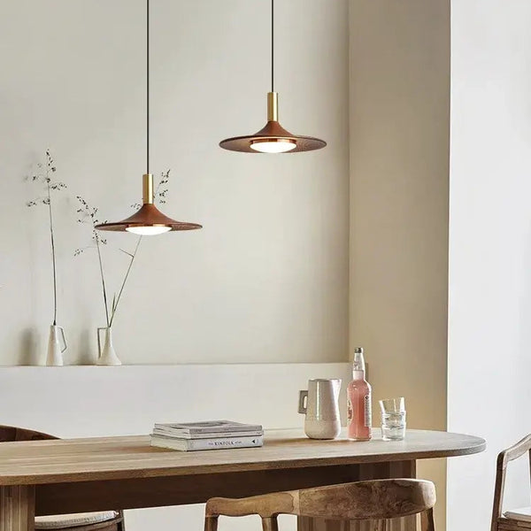 Walnut Mid Century Modern Chandelier hanging above a stylish wooden table in a cozy indoor setting.