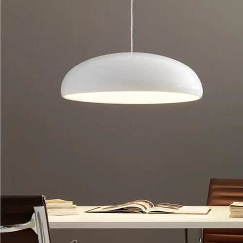 Simple Hanging Lamp with glossy finish illuminating a dining area, showcasing modern design.