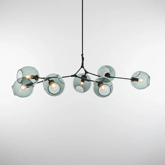hero Modern chandelier hanging above a sofa with abstract wall art in the background