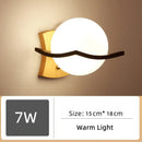 Wood and Frosted Glass Japanese Minimalist Sconces featuring warm light and sleek design.