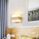Wood and Frosted Glass Japanese Minimalist Sconces mounted on a wall, illuminating a serene bedroom atmosphere.