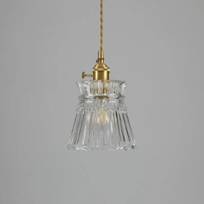 Elegant Glass Pendant Light with Brass Accents - Illuminate with Style showcasing clear glass and brass fixtures.