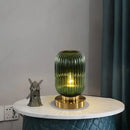 Modern Nordic Glass Table Lighting Fixtures in dark green with a gold base, enhancing interior decor.