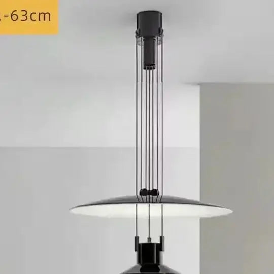 Modern pendant light with black and white design on a gray background