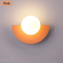 Halfmoon Metal Sconce in pink, modern Nordic design wall lamp with LED light, suitable for various spaces.