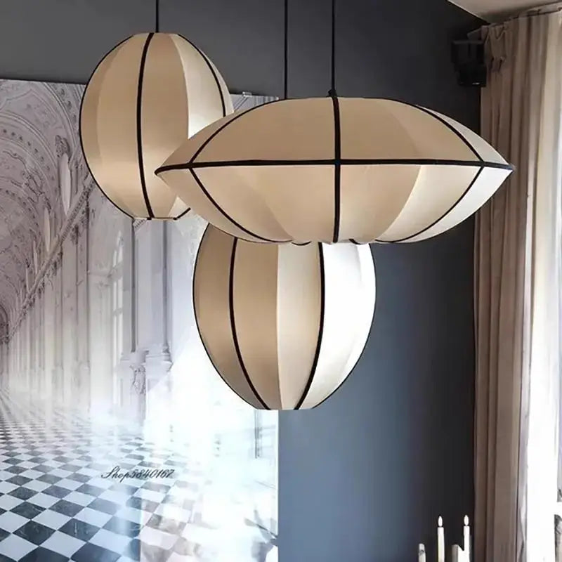 Zen Silk Pendant Light Mid Century Fabric Lantern in elegant sculptural form, enhancing modern interiors with warm illumination.