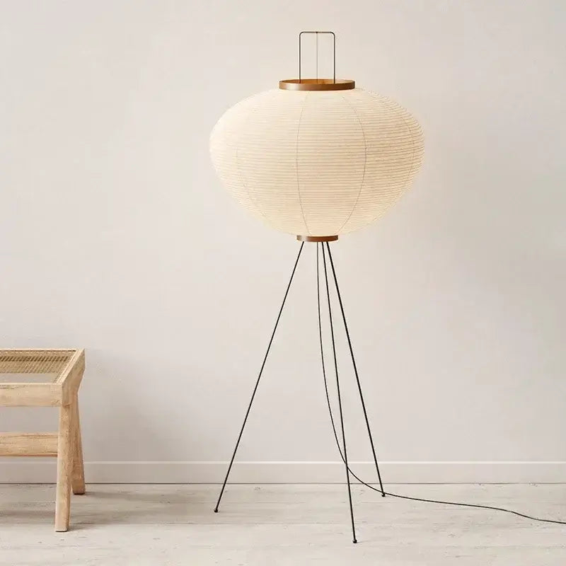 Hero. Japanese Rice Paper Floor lamp with a round paper shade and wooden base in a minimalistic room.