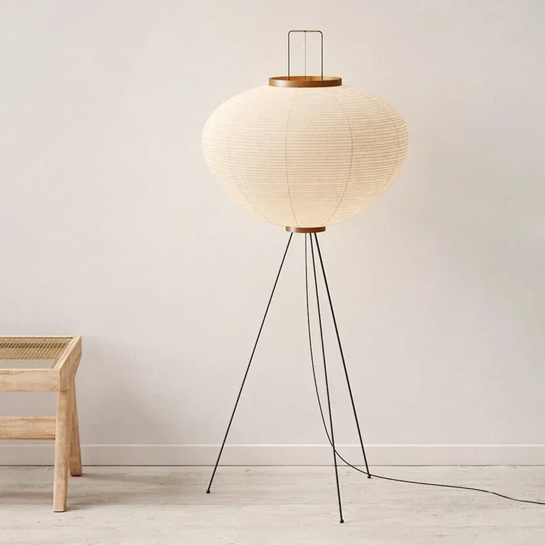 Hero. Japanese Rice Paper Floor lamp with a round paper shade and wooden base in a minimalistic room.