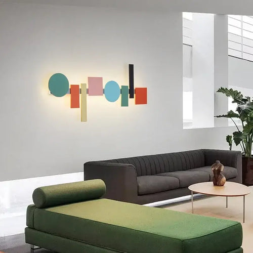 Multicolour Wall Totem LED geometric light illuminating a modern living room with stylish furniture.