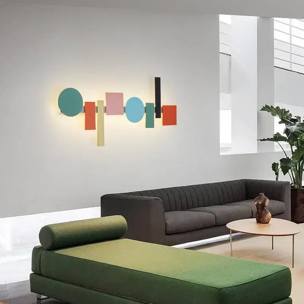Multicolour Wall Totem LED geometric light illuminating a modern living room with stylish furniture.