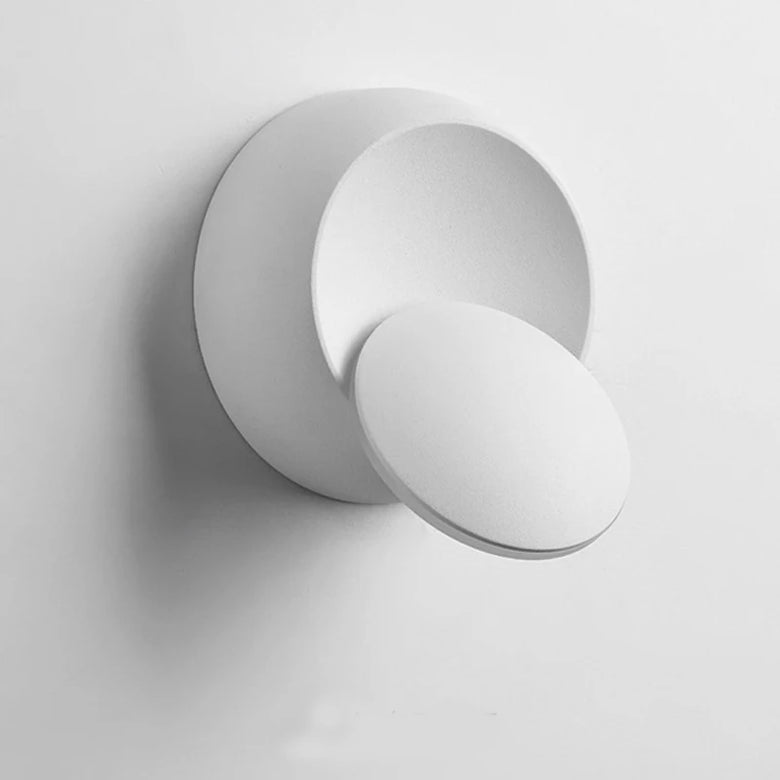 Modern white round wall light fixture on a white background