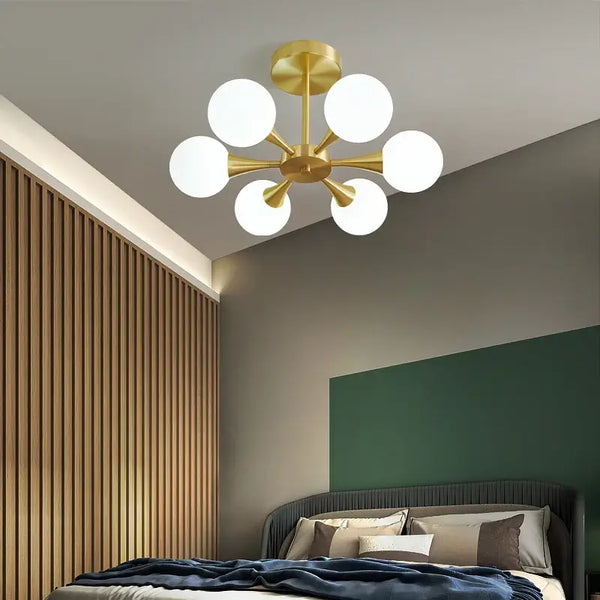 Modern Copper Glass Ball Chandelier illuminating a stylish bedroom with a Mid-Century Modern design.