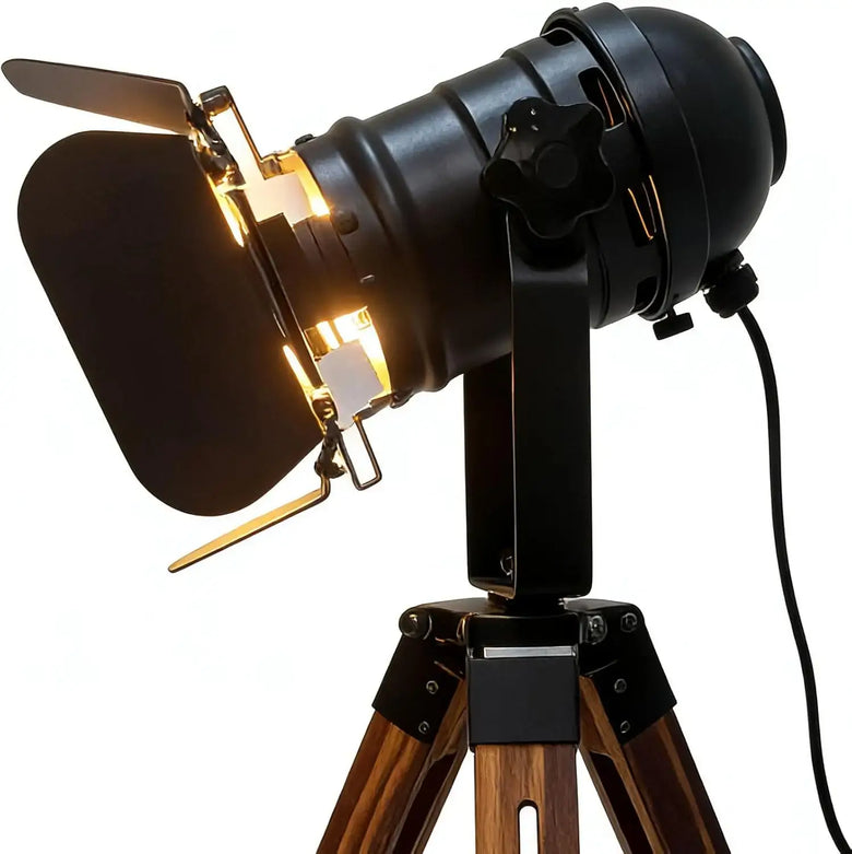 Vintage-style studio light on a wooden tripod with a white background
