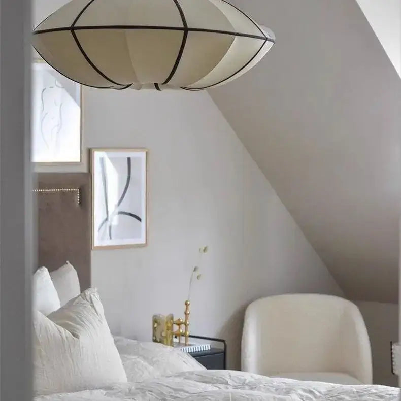 Zen Silk Pendant Light Mid Century Fabric Lantern illuminating a serene bedroom with elegant decor.