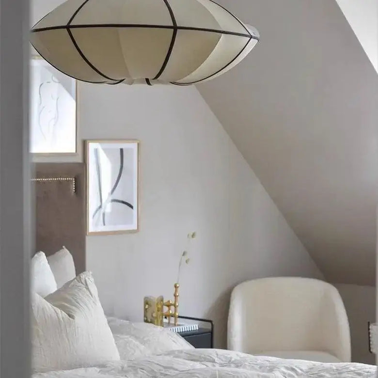 Zen Silk Pendant Light Mid Century Fabric Lantern illuminating a serene bedroom with elegant decor.