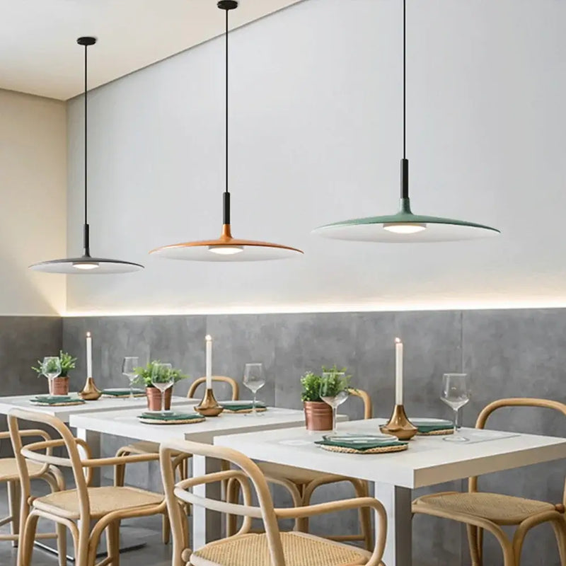 Sleek, Modern Led Pendant Lamps hanging above a contemporary dining table with stylish decor.