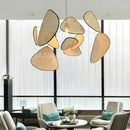 Mid-Century Modern Rattan Wall Light hanging in a contemporary living room with modern furniture and large windows.