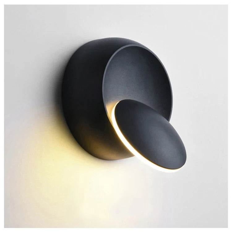 Modern round lack wall light fixture on a white background