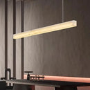 Natural Marble Linear Pendant Light 80–120cm illuminating a modern dining space.