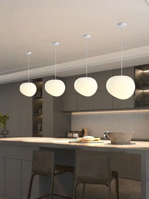 Simple Nordic Restaurant Pebble Chandelier hanging above modern kitchen island with minimalist design
